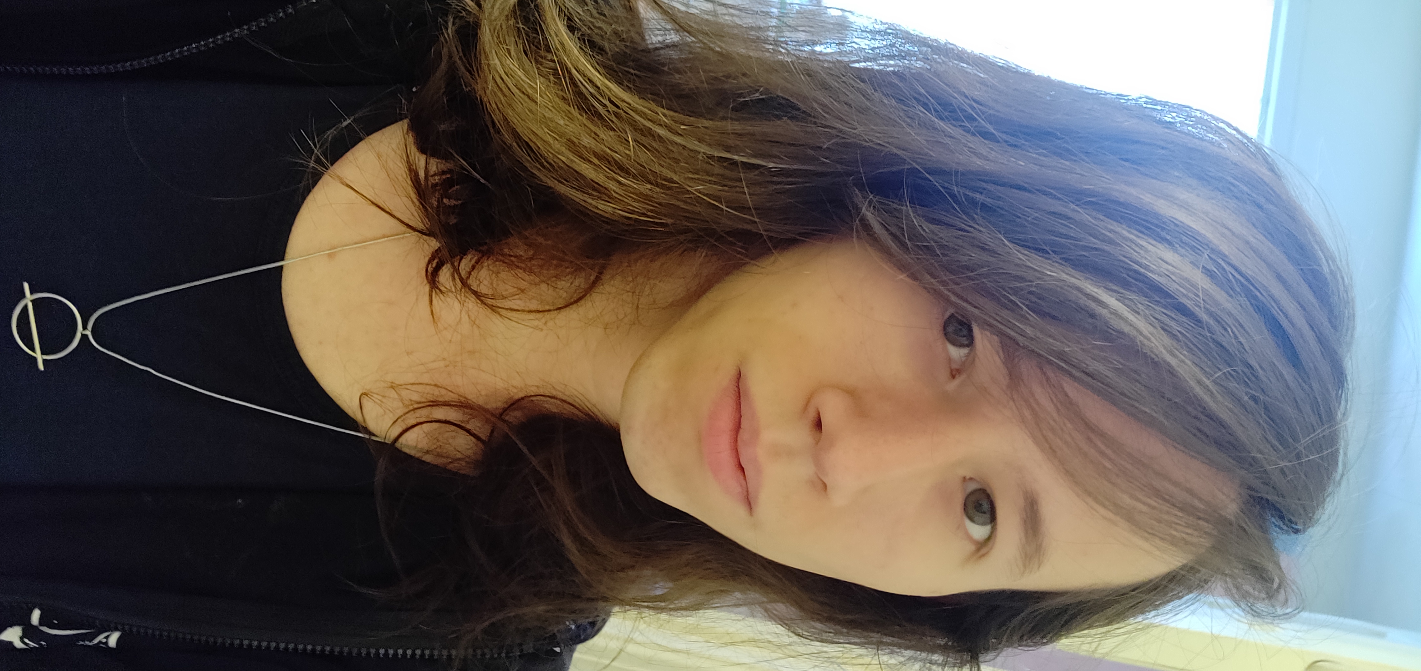 Brown-haired girl with a neutral expression.
